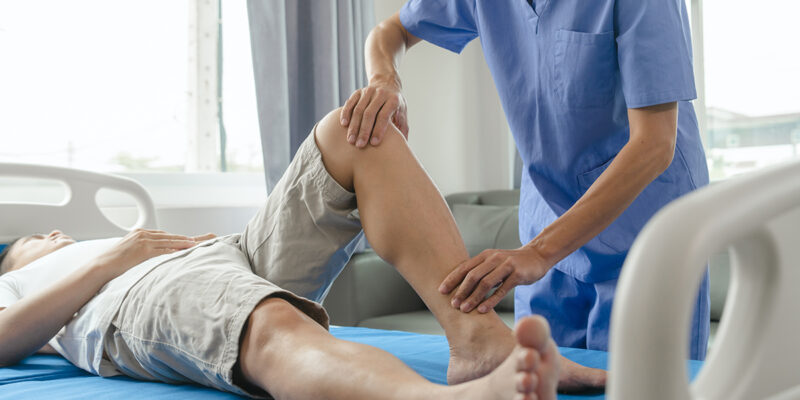 physical therapist assisting patient